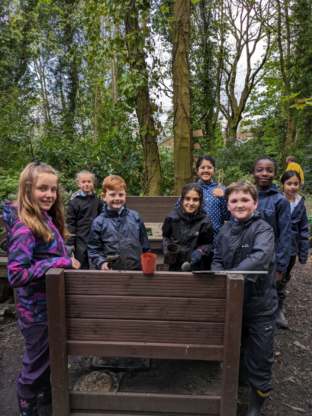 A group of Year 4 students stood together in the Forest School area